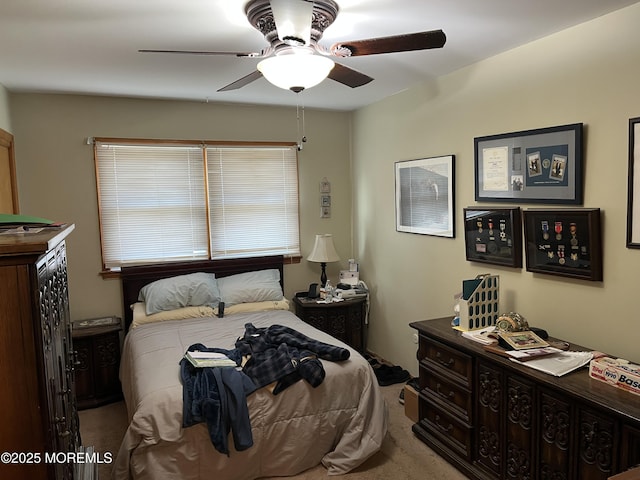 bedroom featuring a ceiling fan and light colored carpet