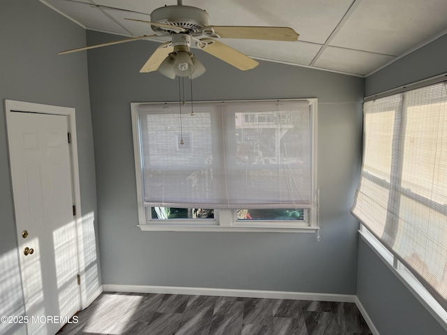 unfurnished room featuring ceiling fan, baseboards, vaulted ceiling, and dark wood finished floors