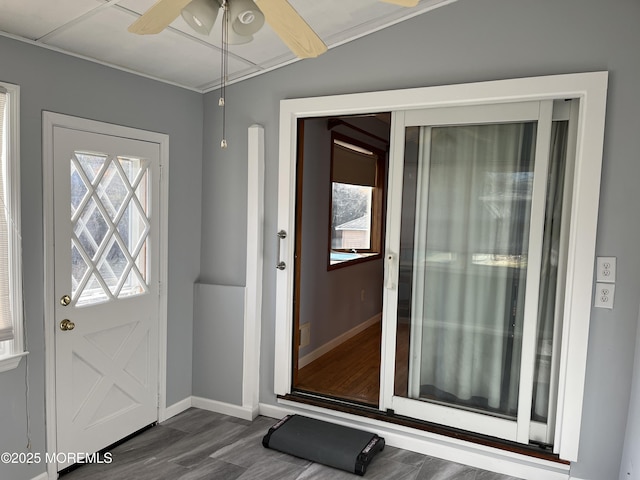 doorway to outside with ceiling fan, baseboards, dark wood-style flooring, and a wealth of natural light