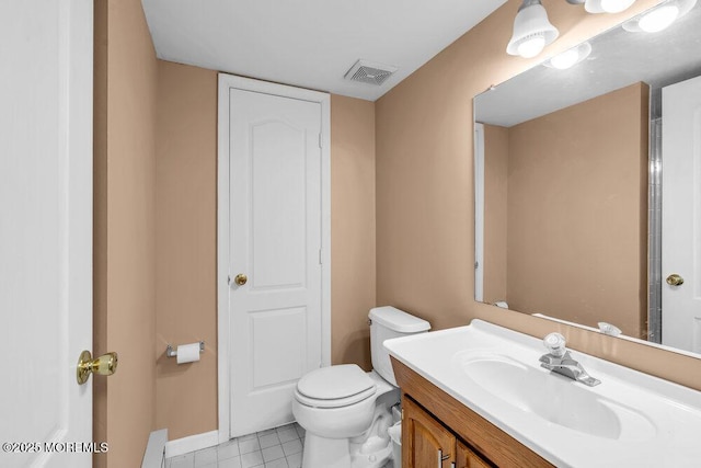 bathroom featuring a closet, visible vents, toilet, vanity, and tile patterned floors