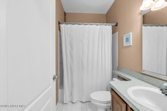 full bathroom featuring tile patterned floors, vanity, toilet, and shower / bath combo with shower curtain