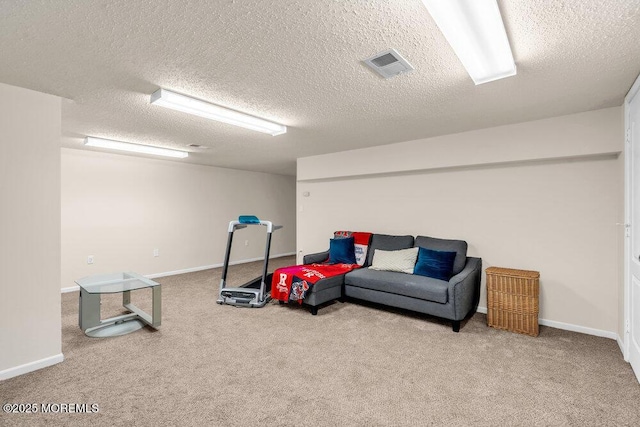 playroom featuring a textured ceiling, carpet flooring, visible vents, and baseboards