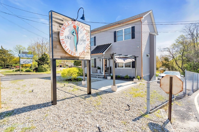 view of front of home featuring fence