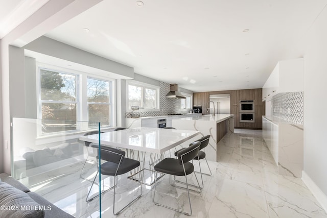 dining space featuring marble finish floor and baseboards