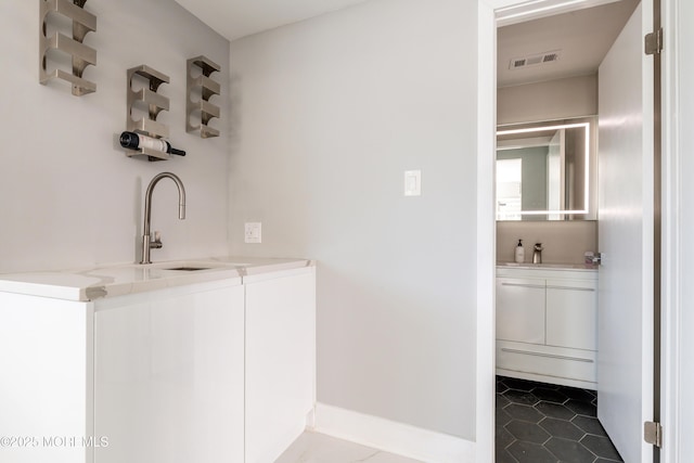 bathroom featuring visible vents, vanity, and tile patterned floors