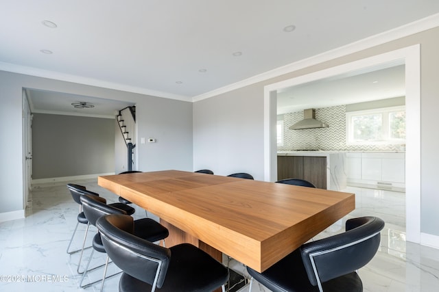 dining space with marble finish floor, baseboards, and crown molding