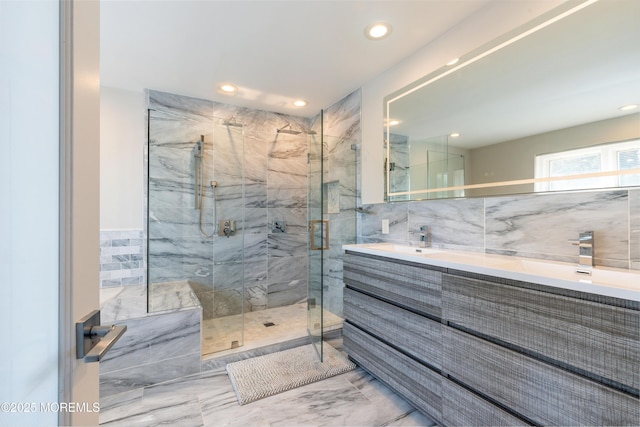 bathroom with marble finish floor, a marble finish shower, tile walls, and recessed lighting