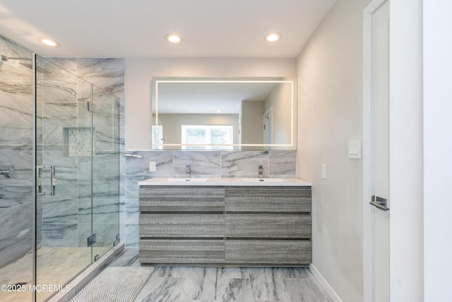 bathroom with recessed lighting, a sink, a shower stall, and double vanity