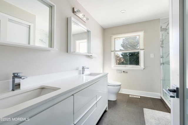 bathroom featuring visible vents, a sink, a shower stall, and toilet