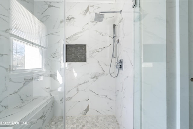 bathroom with a marble finish shower