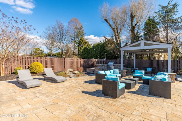 view of patio / terrace featuring a fenced backyard, an outdoor living space, and area for grilling