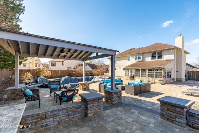 view of patio / terrace with outdoor lounge area, a fenced backyard, and a ceiling fan