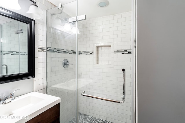 full bathroom with a shower stall and vanity