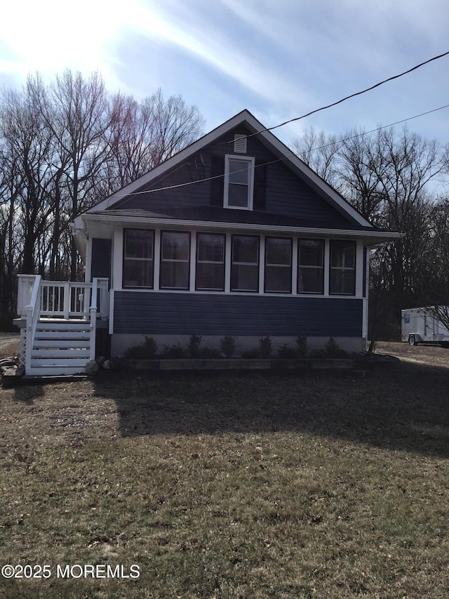 exterior space with a wooden deck and a front yard