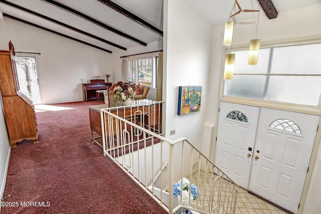 entryway featuring vaulted ceiling with beams and carpet