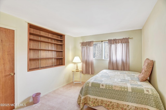 carpeted bedroom featuring baseboards