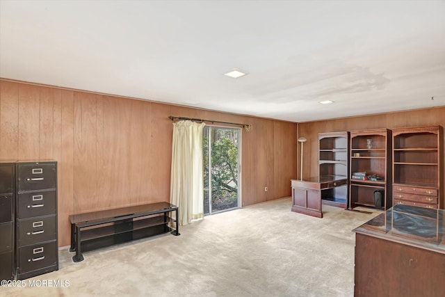 office with carpet flooring and wood walls