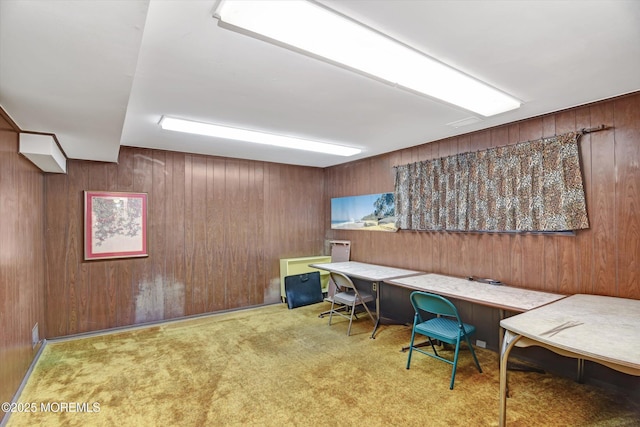 home office featuring wooden walls and carpet flooring