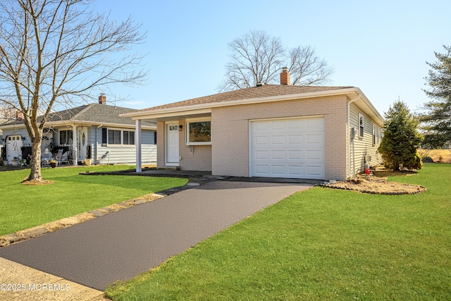 single story home with driveway, a chimney, an attached garage, a front lawn, and brick siding