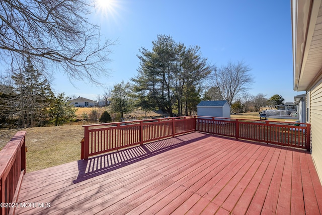 wooden terrace with a shed and an outbuilding