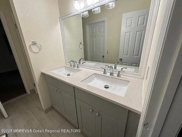 bathroom with a sink and double vanity