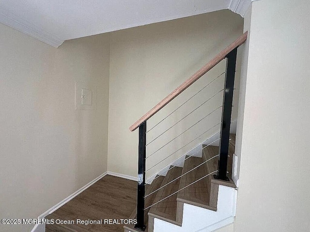 stairway with wood finished floors and baseboards