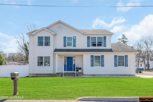 view of front of property with fence and a front yard