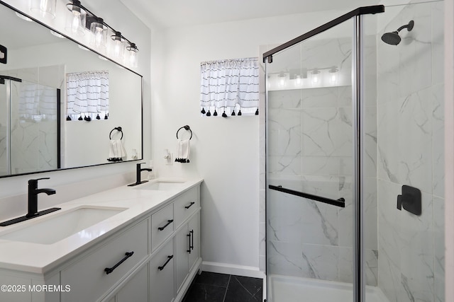 bathroom featuring double vanity, a marble finish shower, and a sink