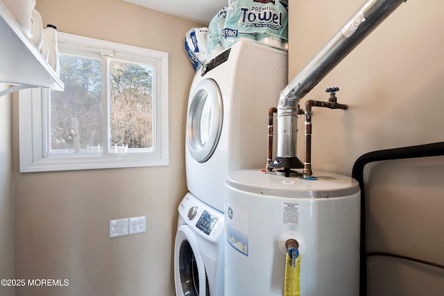 washroom with laundry area, water heater, and stacked washer and dryer