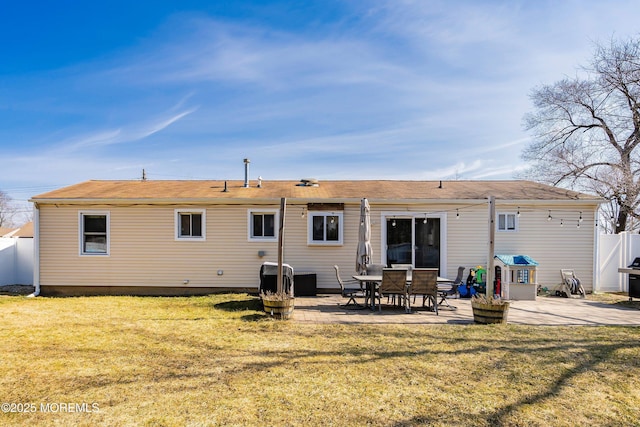 back of property with a patio area, fence, and a yard