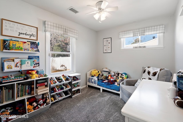 bedroom featuring visible vents, dark carpet, and ceiling fan