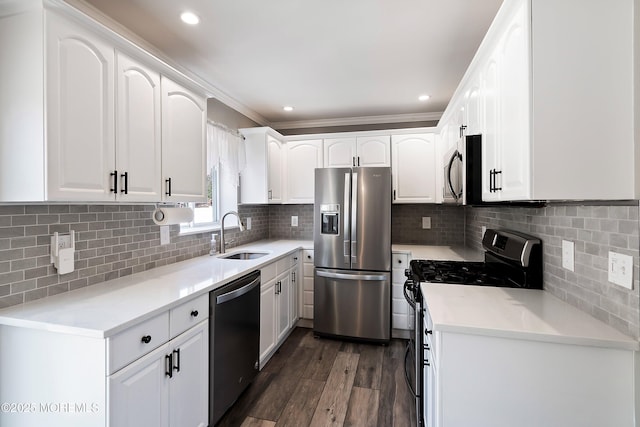 kitchen with dark wood finished floors, light countertops, appliances with stainless steel finishes, white cabinets, and a sink