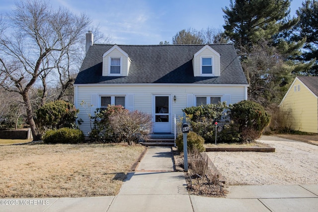 cape cod house featuring entry steps and a shingled roof