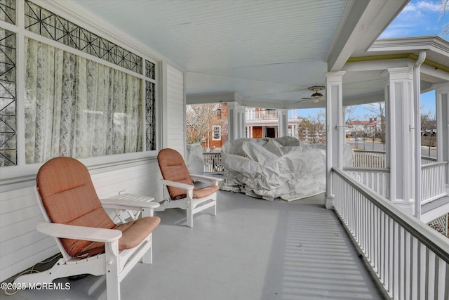 exterior space featuring decorative columns and ceiling fan