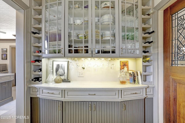 bar featuring light tile patterned floors and built in shelves