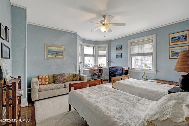 bedroom with ceiling fan, dark wood-style flooring, and crown molding