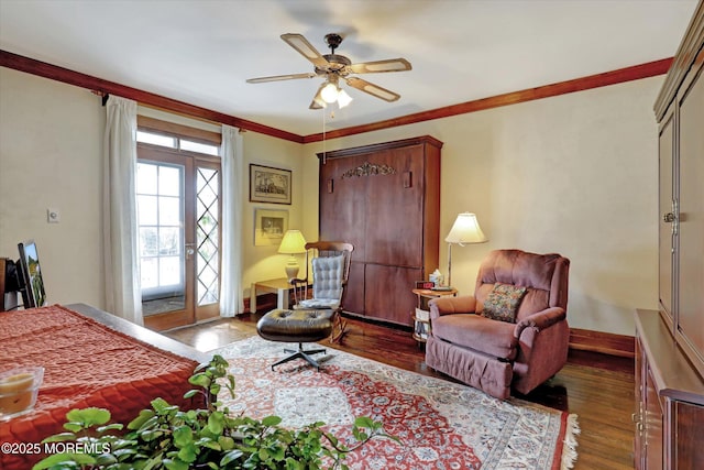 bedroom featuring crown molding, baseboards, and wood finished floors