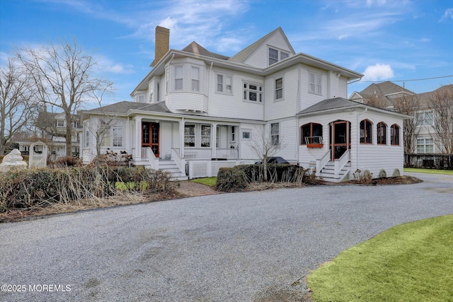 view of front of property featuring a porch and a chimney