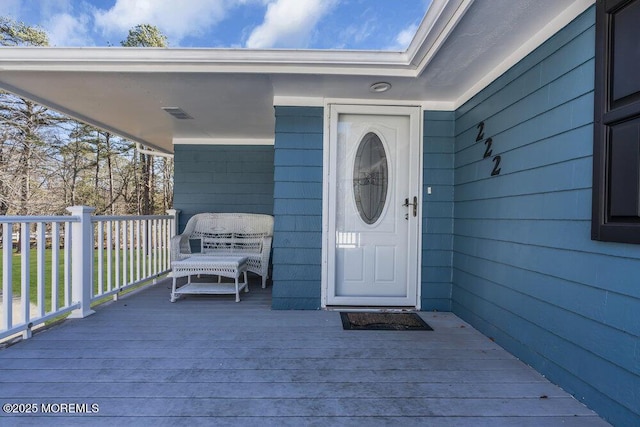 property entrance featuring a wooden deck