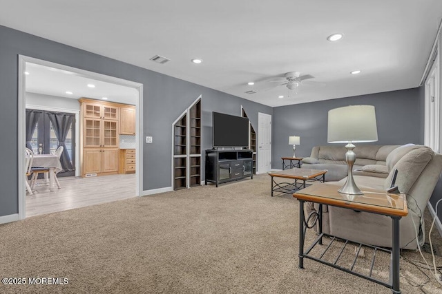 living room with light carpet, visible vents, a ceiling fan, and recessed lighting