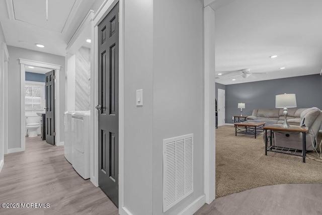 hall with carpet, recessed lighting, visible vents, attic access, and baseboards