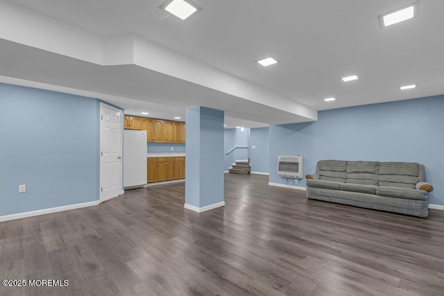 unfurnished living room featuring stairs, baseboards, dark wood-style floors, and heating unit