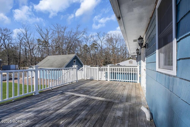 wooden deck with an outbuilding and a yard