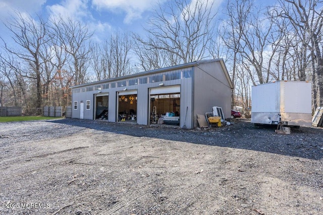 detached garage featuring fence