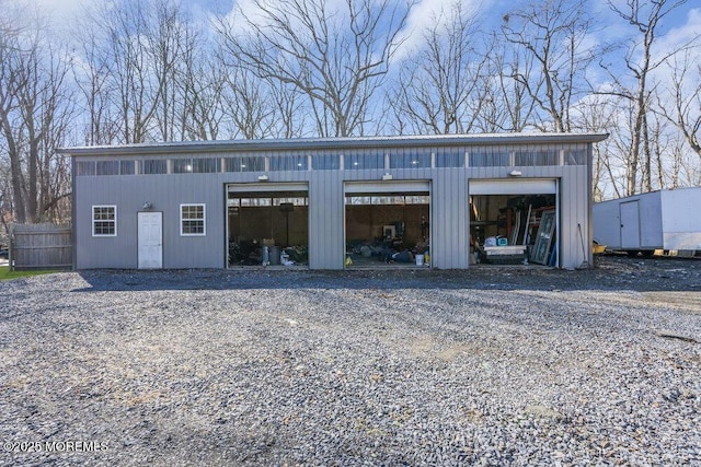 detached garage featuring fence