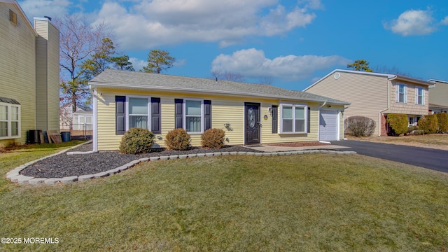 view of front of house featuring aphalt driveway, an attached garage, and a front lawn