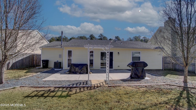 rear view of house with central AC, a lawn, a patio area, and a fenced backyard