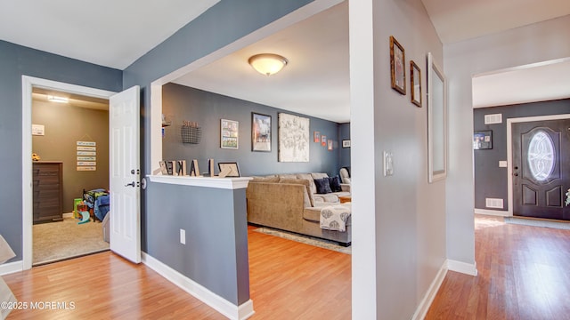 hallway with baseboards and wood finished floors