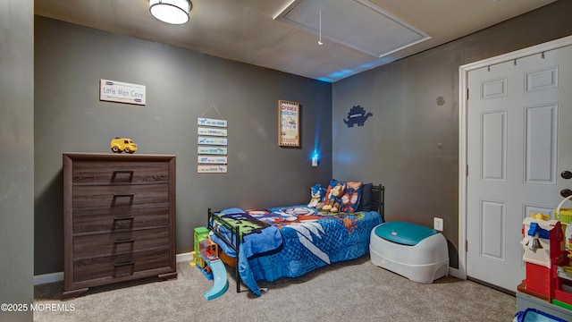 bedroom featuring carpet, attic access, and baseboards