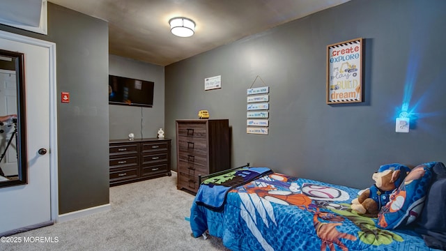 bedroom featuring light colored carpet and baseboards